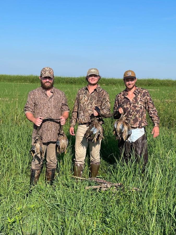 Three hunters with morning straps in a South Louisiana pasture